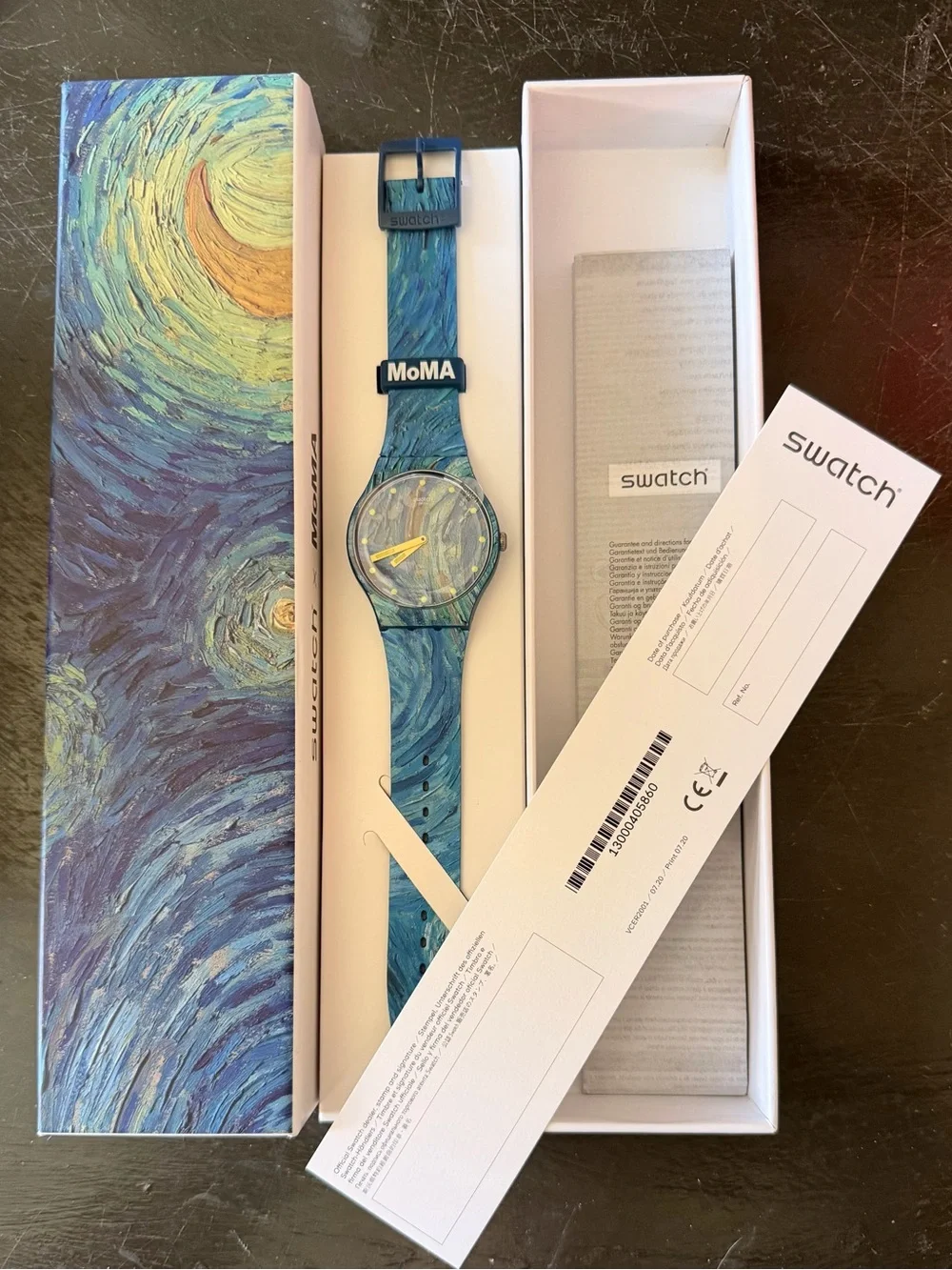 Swatch blue marbled dial and strap watch with yellow hands